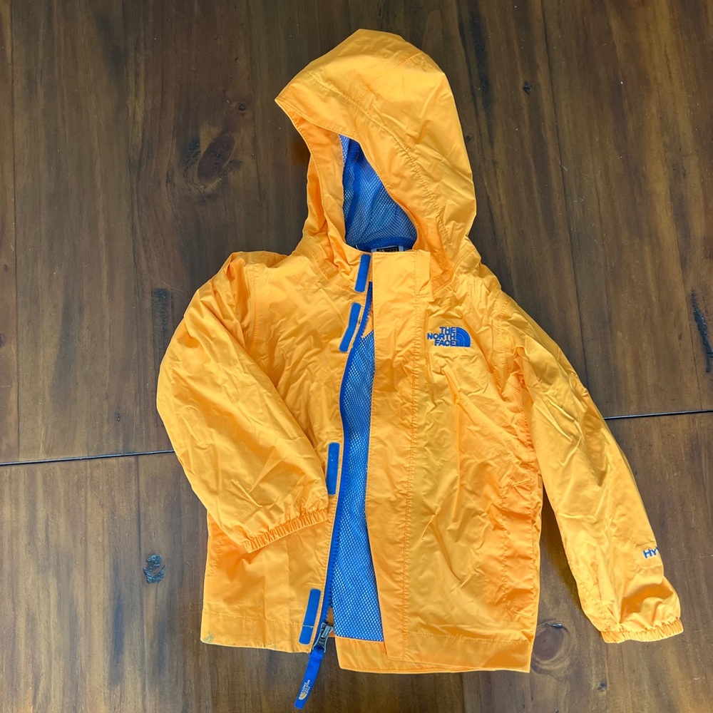 The North Face Vibrant Orange Rain Jacket with Blue Lining